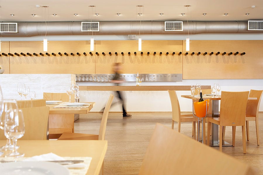 wine tasting room with wood tables and chairs at Boutari Crete Winery
